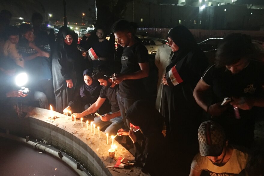 Protesters light candles in commemoration of young men killed by security forces in anti-government demonstrations in Basra in early September.