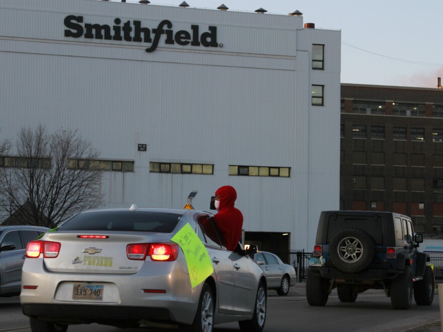 Employees and family members protest outside a Smithfield Foods processing plant in Sioux Falls, S.D., on April 9. Smithfield is being sued over its handling of the coronavirus pandemic.