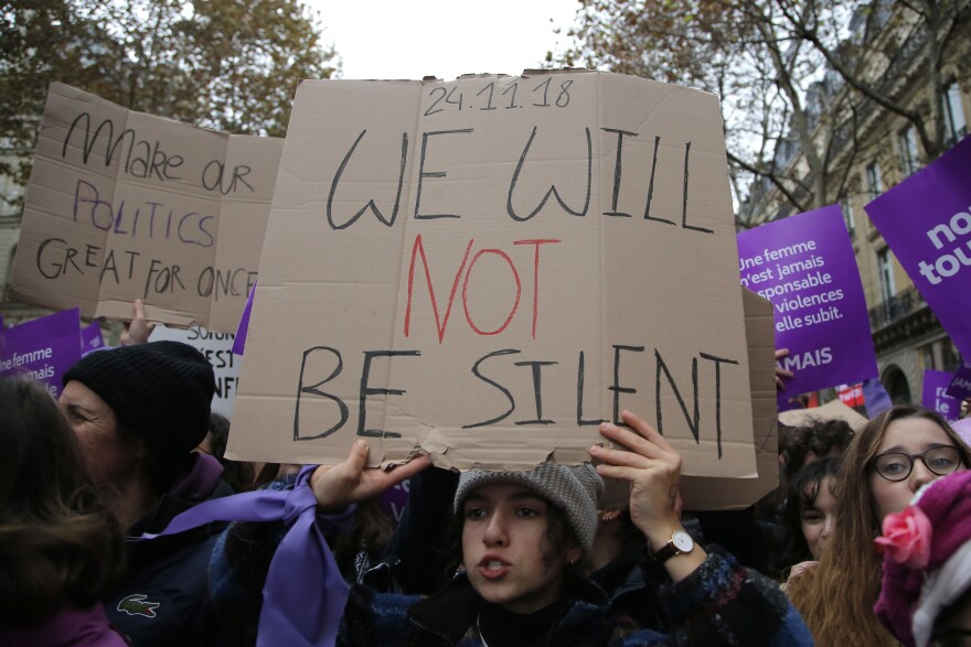 A woman demonstrates against violence against women Saturday, Nov. 24, 2018 in Paris. 