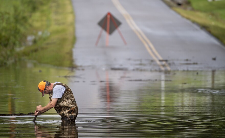 Dickson Public Works personnel check the flooding on Old Pond Lane following heavy rainfall on Saturday in Dickson, Tenn. Heavy flooding in several Middle Tennessee counties on Saturday prompted water rescues, road closures, and communications disruptions, with several people killed.