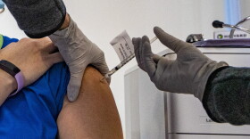 Pfizer's COVID-19 vaccination is administered to a Tufts Medical Center employee on Dec. 15. (Jesse Costa/WBUR)