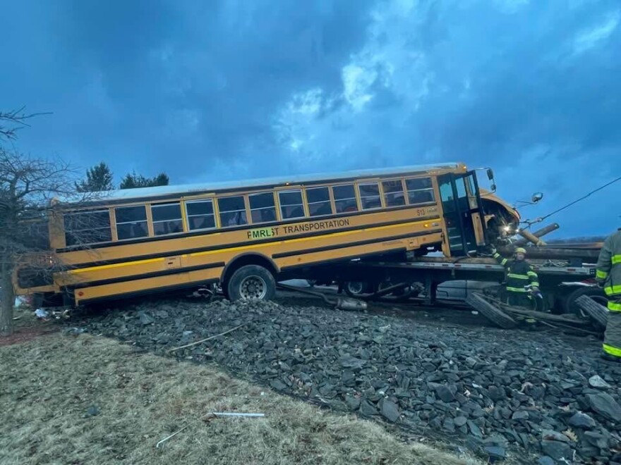 The Black Diamonds Pipe Band's bus landed on a flatbed truck after losing control.