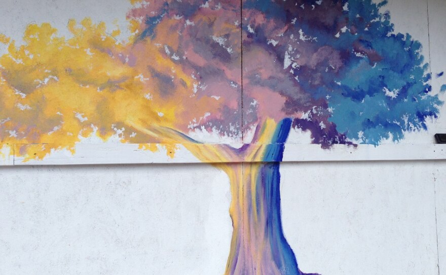 Darcy Edwin is painting an oak tree