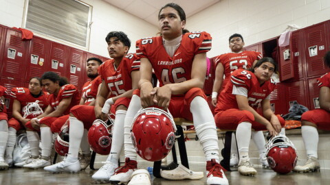 FILE - Lahainaluna High School football team players listen to co-head coach Dean Rickard before their homecoming game at Sue D. Cooley Stadium, Saturday, Oct. 21, 2023, in Lahaina.