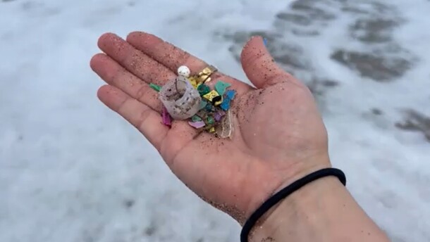hand holding various microplastics 
