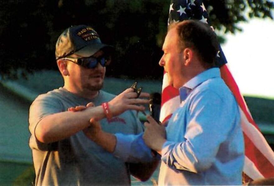 A photo included in a federal complaint filed July 23, 2022, shows David Jakubonis approaching Lee Zeldin with the keychain device at the VFW Post in the Town of Perinton near Rochester July 22, 2022.