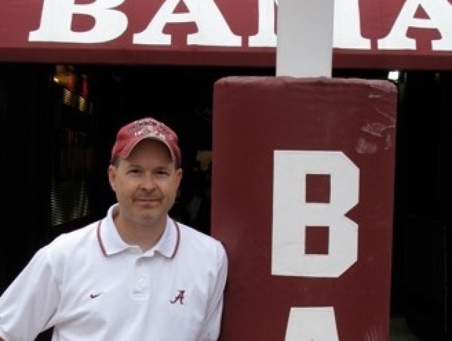 Monique Fields, an unofficial, unpaid football assistant, snapped this picture of her husband, Ken, standing at the goalpost at Bryant-Denny Stadium.