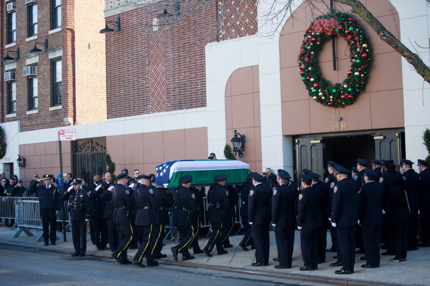 Ramos' casket is carried into the church.