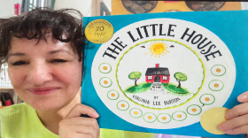 Sandra Cisneros holds up a copy of The Little House by Virginia Lee Burton.