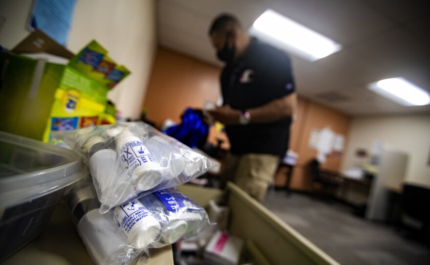 At his office in the Lynn Community Health Center, Will packs a backpack with sterile syringes, Narcan and safety kits to distribute to drug users on the streets to keep them safe from the risks associated with drug use.