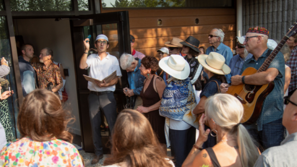 Rabbi Josh Kleyman and song leader Judd Grossman lead the Jackson Hole Jewish Community to affix a mezuzah on the front door of a new synagogue.