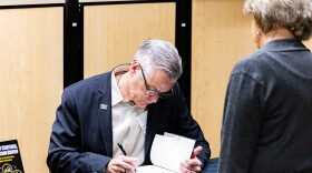 President Richard Muma signs Director of RSC Events Maria Ciski's copy of "Student Centered, Innovation Driven." Copies are available for purchase in the Shocker Store.