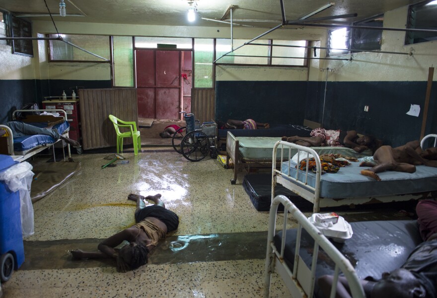 Two people lie dead on the floor inside the critical ward of the Redemption Hospital, which has become a transfer and holding center for Ebola patients, located in one of the poorest neighborhoods of Monrovia.