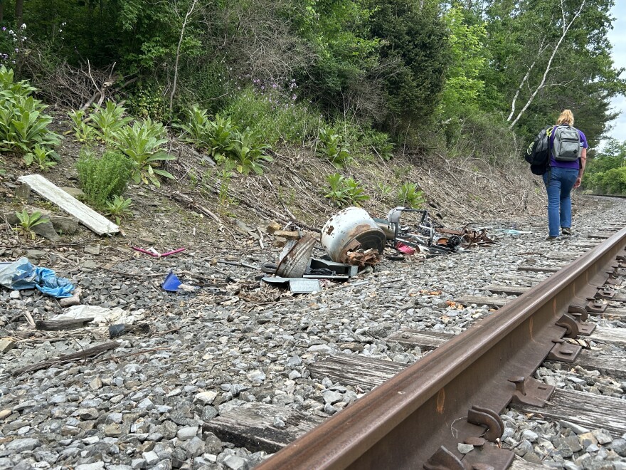 A worker who does homeless outreach walks along train tracks in Corning.