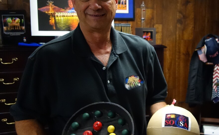 Jim Souza, president of Pyro Spectaculars, poses with samples of some of the fireworks he's planning for this year's Macy's show.