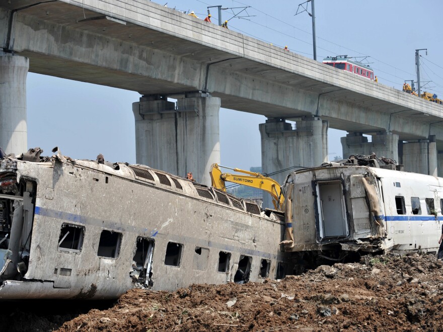 Workers prepare to clear away wrecked train cars in Wenzhou, in China's Zhejiang province, after the crash of a bullet train in 2011.