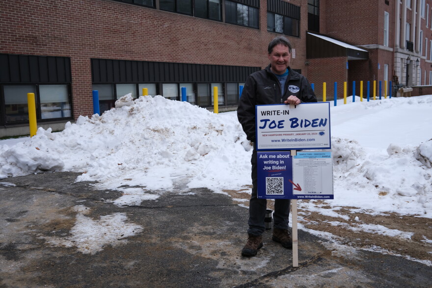 Scott Burns stood outside of a Franklin polling place in the cold Tuesday morning with a sign urging voters to write in Joe Biden's name.