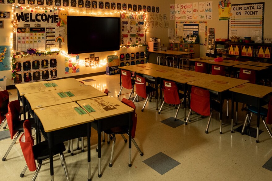  A classroom in evening light, with warm shadows across rows of desks