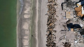 FILE - Waves lap on the beach in front of empty house foundations surrounded by debris, following the passage of Hurricane Milton, on Manasota Key, in Englewood, Fla., Oct. 13, 2024. (AP Photo/Rebecca Blackwell, File)