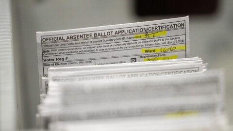 FILE - Absentee ballots are seen during a count at the Wisconsin Center for the midterm election Tuesday, Nov. 8, 2022, in Milwaukee. A federal judge has thrown out a lawsuit brought by Democrats that challenged Wisconsin’s witness requirements for absentee voting, a ruling that keeps the law in place with the presidential election six months away. U.S. District Court Judge James Peterson tossed the lawsuit Thursday, May 9, 2024, saying the fact that the law has stood unchallenged in one form or another since the 1960s was “telling.”