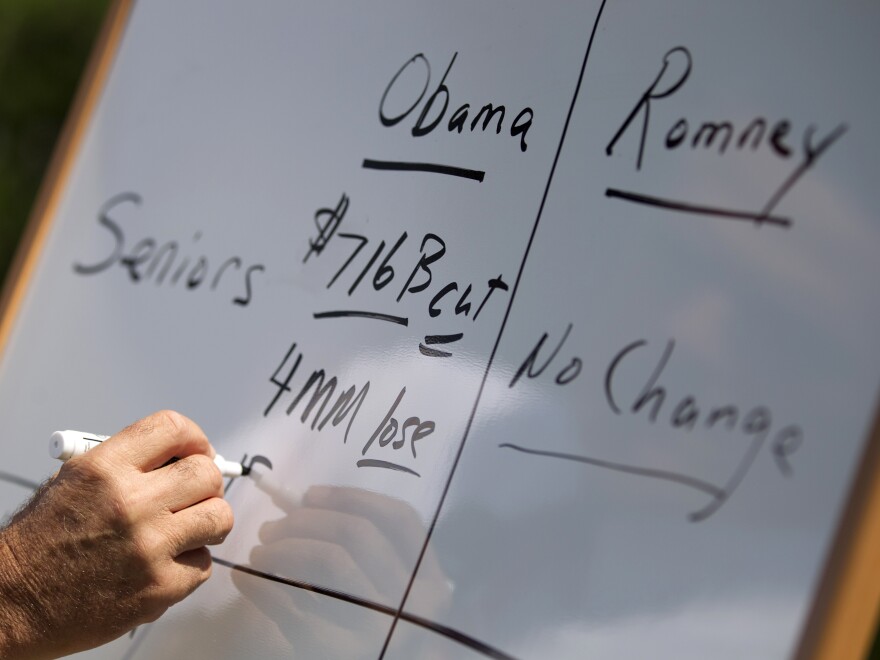 Mitt Romney writes on a whiteboard as he talks about Medicare during a news conference on Aug. 16 in Greer, S.C.