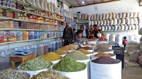 People shop at a spice and grain market in Yemen's capital Sanaa.