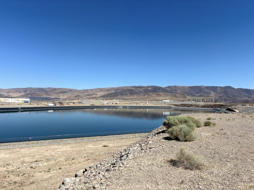 This is an image of the large reservoir at the Tahoe Reno Industrial Center in the middle of the high desert on a blue-skied day.