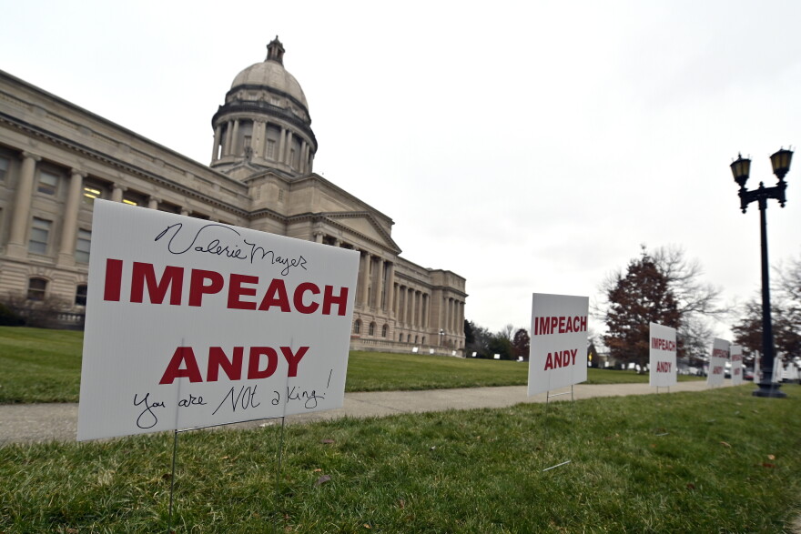 Signs, some with personal messages promoting the impeachment of Kentucky Governor Andy Beshear, line the walkway and lawn of the State Capitol building in Frankfort, Ky., Tuesday, Jan. 5, 2021.