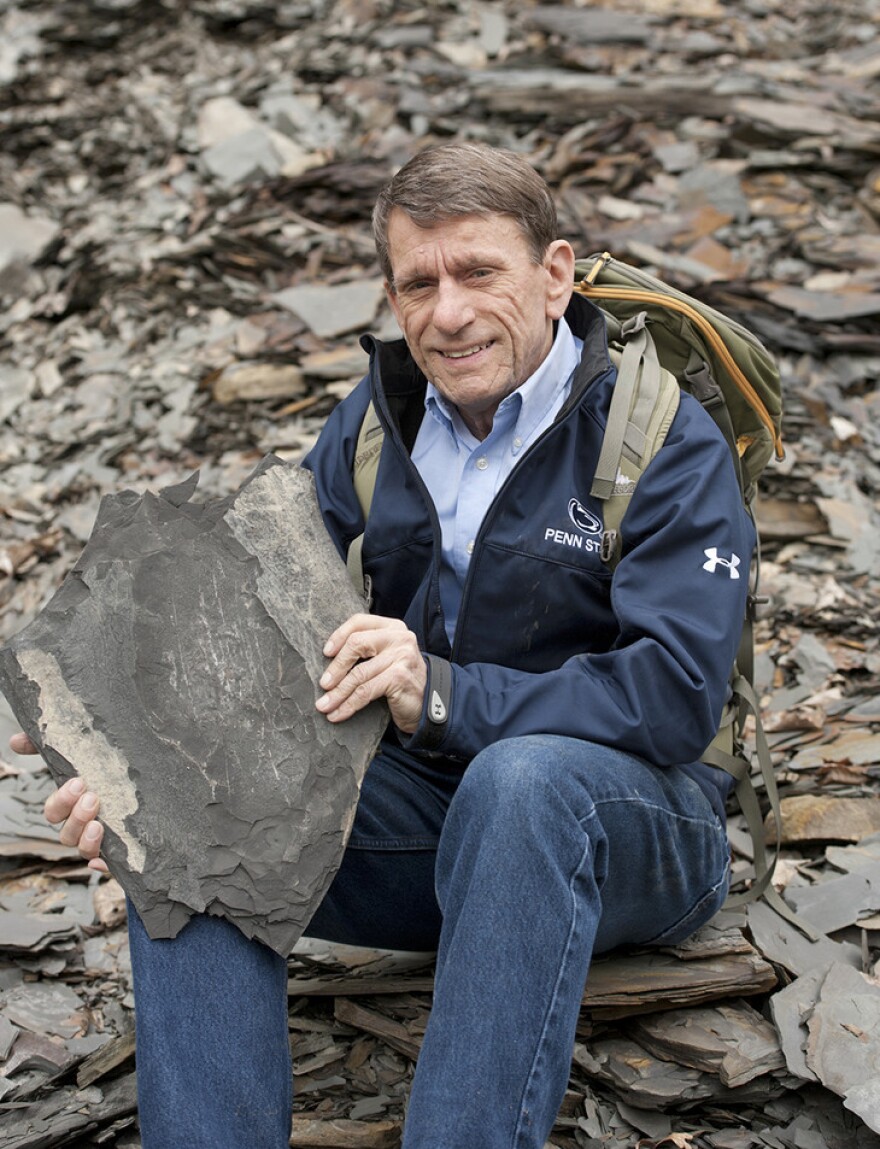 Terry Engelder, professor emeritus of geosciences at Penn State, holding a large rock.