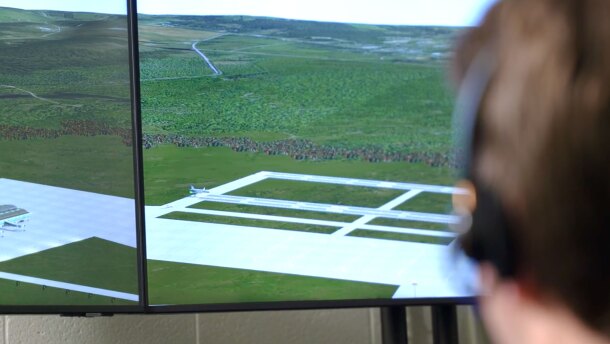 At USU’s air traffic control simulator, students try their hand at directing virtual air traffic displayed on monitors via voice commands to computer software. The simulator helps them learn the complex phraseology and operations aviation requires.