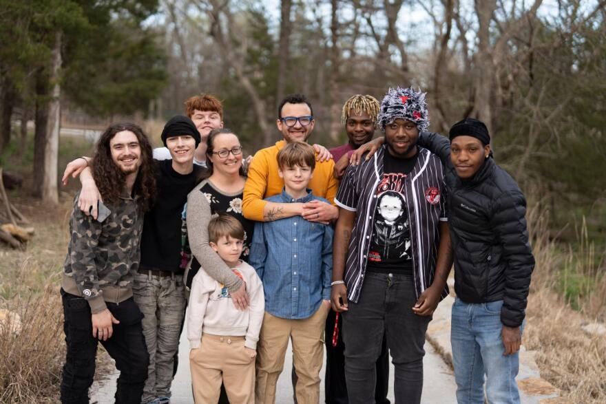 Jonathan and Katie Stahls' family consisting of biological children and several adopted foster children pose for a family photo.