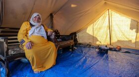 A woman sits in a tent at a refugee camp set up for Palestinians seeking refuge along the Gaza Strip in Khan Yunis, Gaza.