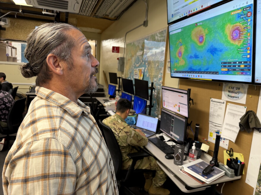 David Lopez, administrator of the Hawaiʻi Emergency Management Agency, looks at screens inside agency headquarters in Honolulu on Thursday, Sept. 3, 2026.