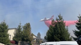 Aerial firefighting crews drop fire retardant on a fire outside of Spokane in 2022. Photo by Jay Wilkins.