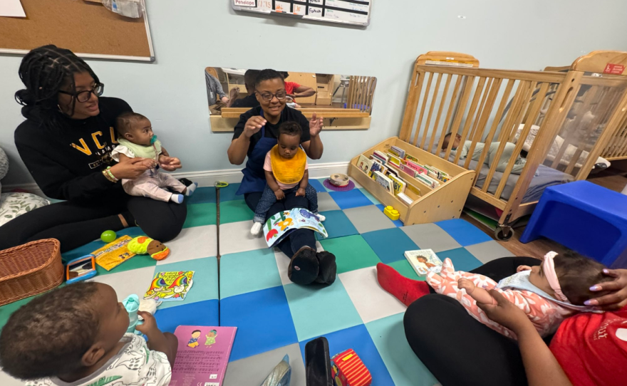 Teachers, including Terri Robinson (middle), sing to infants at the Sprout School in Southside Richmond.