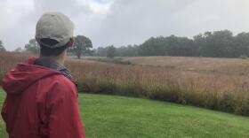 Ornithologist James Marshall sees a break in the clouds over the quiet prairie of Severson Dells Nature Center. He bird bands at the forest preserve every week during the fall migration. He says the number of birds he has banded this year is low compared 