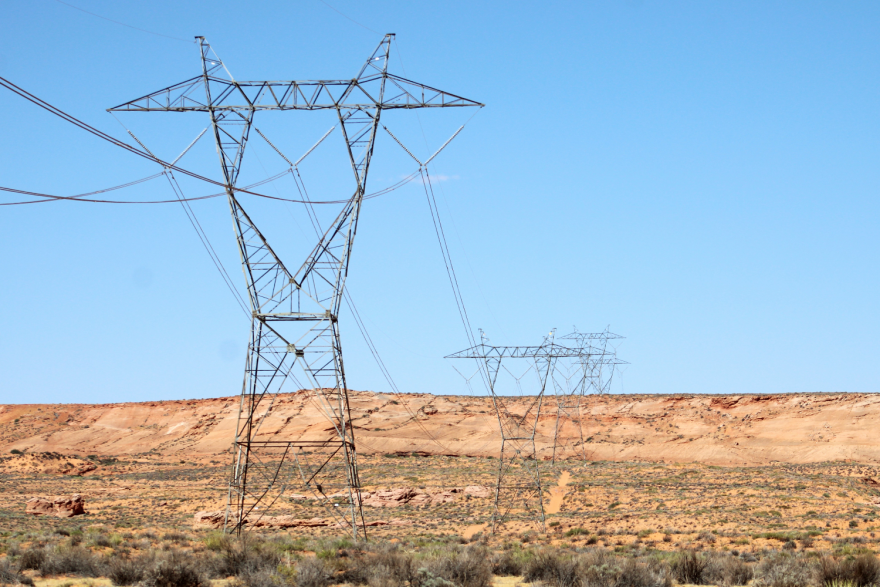 Power lines across a desert landscape.