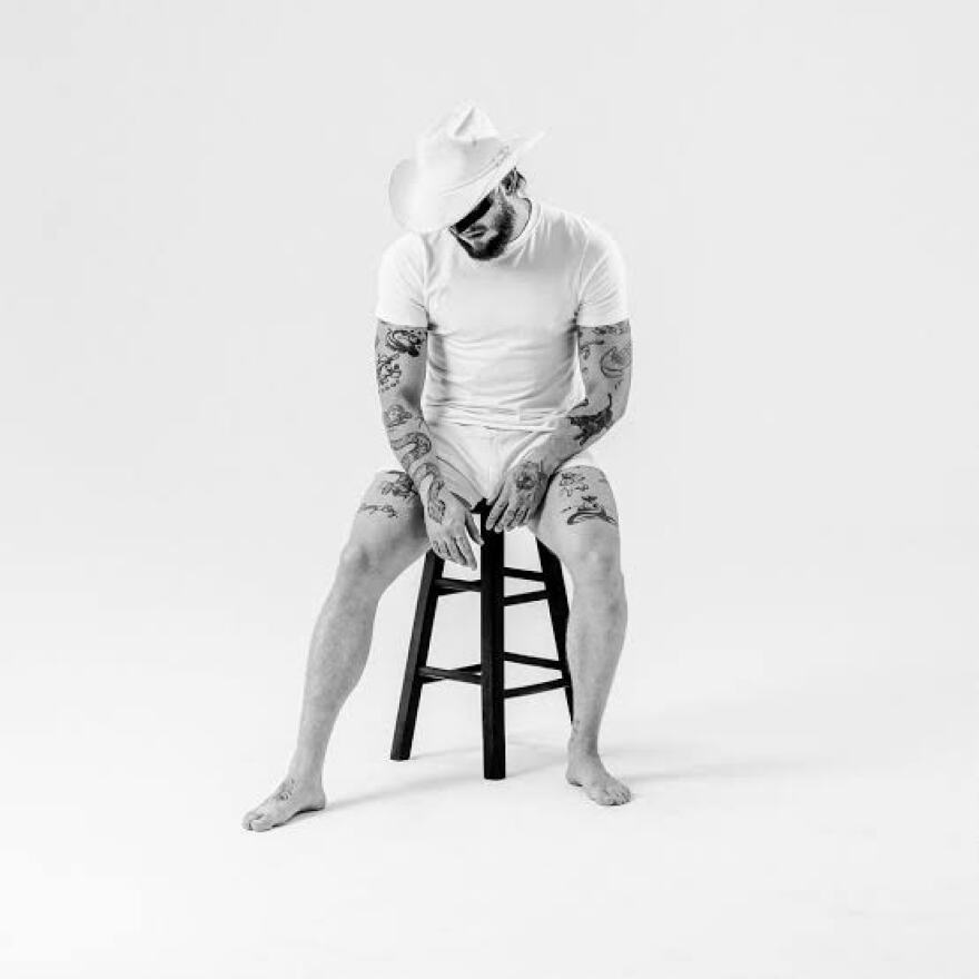a man sitting on a chair wearing a mask