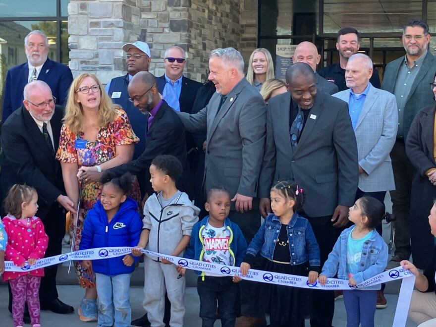 Preparing for the Thursday, Oct. 22 ribbon-cutting (with several Skip-A-Long children) are (L-R in front) Friendship Manor CEO Ted Pappas, SAL Community Services CEO Marcy Mendenhall, Olivet Baptist Church pastor Rev. Damon Colvin, Illinois 17th District Congressman Eric Sorensen, and Rock Island Mayor Ashley Harris.