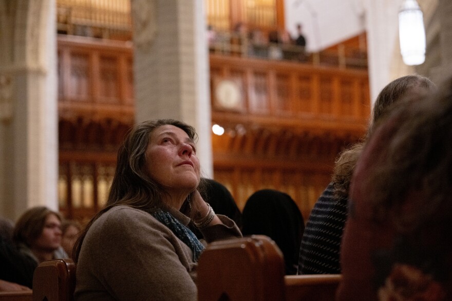 An attendee at the OneLewiston Community Vigil in the Basilica of Saints Peter and Paul in Lewiston, Maine, on Sunday, Oct. 29, 2023. (Raquel C. Zaldívar/New England News Collaborative)