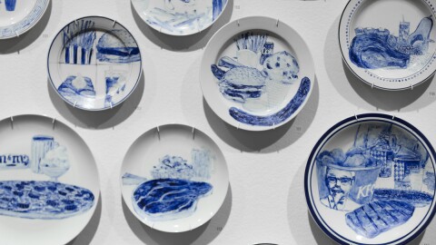 A close-up of Artist Julie Green’s plates exhibited at the Boise Art Museum, hanging on a white wall