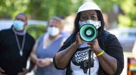 In this Friday, June 19, 2020, photo Jeannine Lee Lake, Democratic candidate for Indiana's 6th congressional district, speaks to the crowd gathered for Juneteenth day event in Columbus, Indiana. The reenergized movement against racial inequality and police brutality following the killing of George Floyd in Minneapolis has amplified the voices of Black candidates across the country. Among them is Lake, who is challenging Rep. Greg Pence, the vice president's brother, in a deeply conserv
