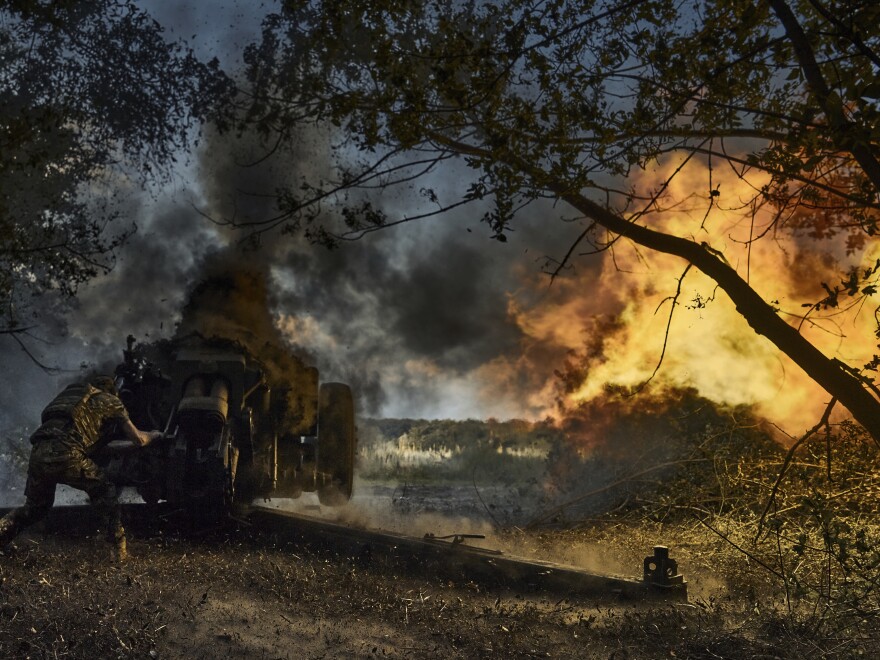 A Ukrainian policeman of a special police unit fires a D-30 cannon towards Russian positions at the front line, near Kreminna, Luhansk region, Ukraine, on Friday.