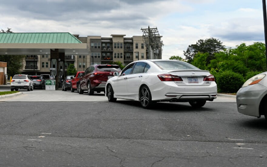 A line of cars waits to get gasoline at a station in Davidson on Tuesday.