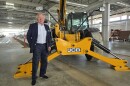 Lord Anthony Bamford, chair of JCB, poses next to equipment made by the company during a tour of its future San Antonio plant on March 30, 2026