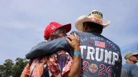 Couple waits for former President Donald Trump to speak at campaign appearance at Sportsman Boats in Summerville, S.C. Sept. 25, 2023.