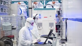 FILE: A photo from November 2021 shows employees in cleanroom "bunny suits" working at an Intel factory in Hillsboro, Oregon.