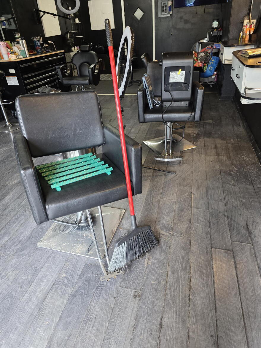 Debris and water damage remained visible on the floors of Second Nature Barber Shop and Salon Friday.