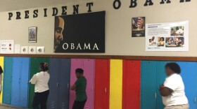 students next to lockers in a line