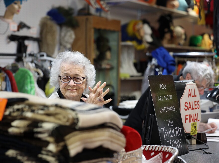 Donna White, a decades-long co-owner of Arlene's Costumes, looks on as customers try on outfits in front of the fitting room mirrors on Thursday, October 23, 2025.